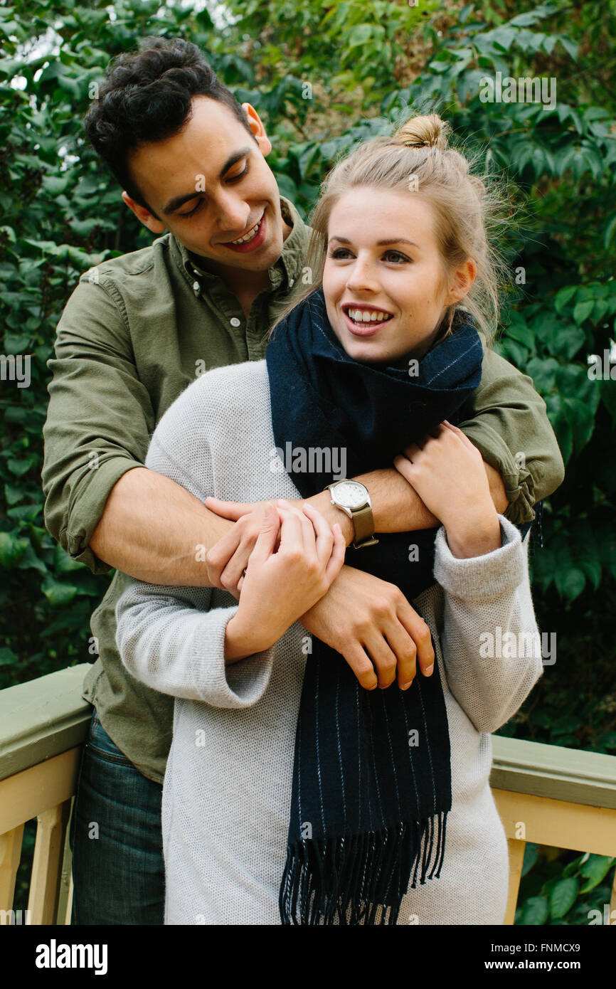 A young couple embrace in their backyard. Detroit MI. Stock Photo