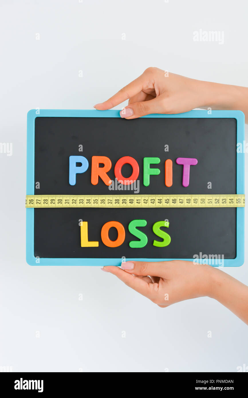 measure your profit concept written as magnetic colored  letter blocks with scale Stock Photo