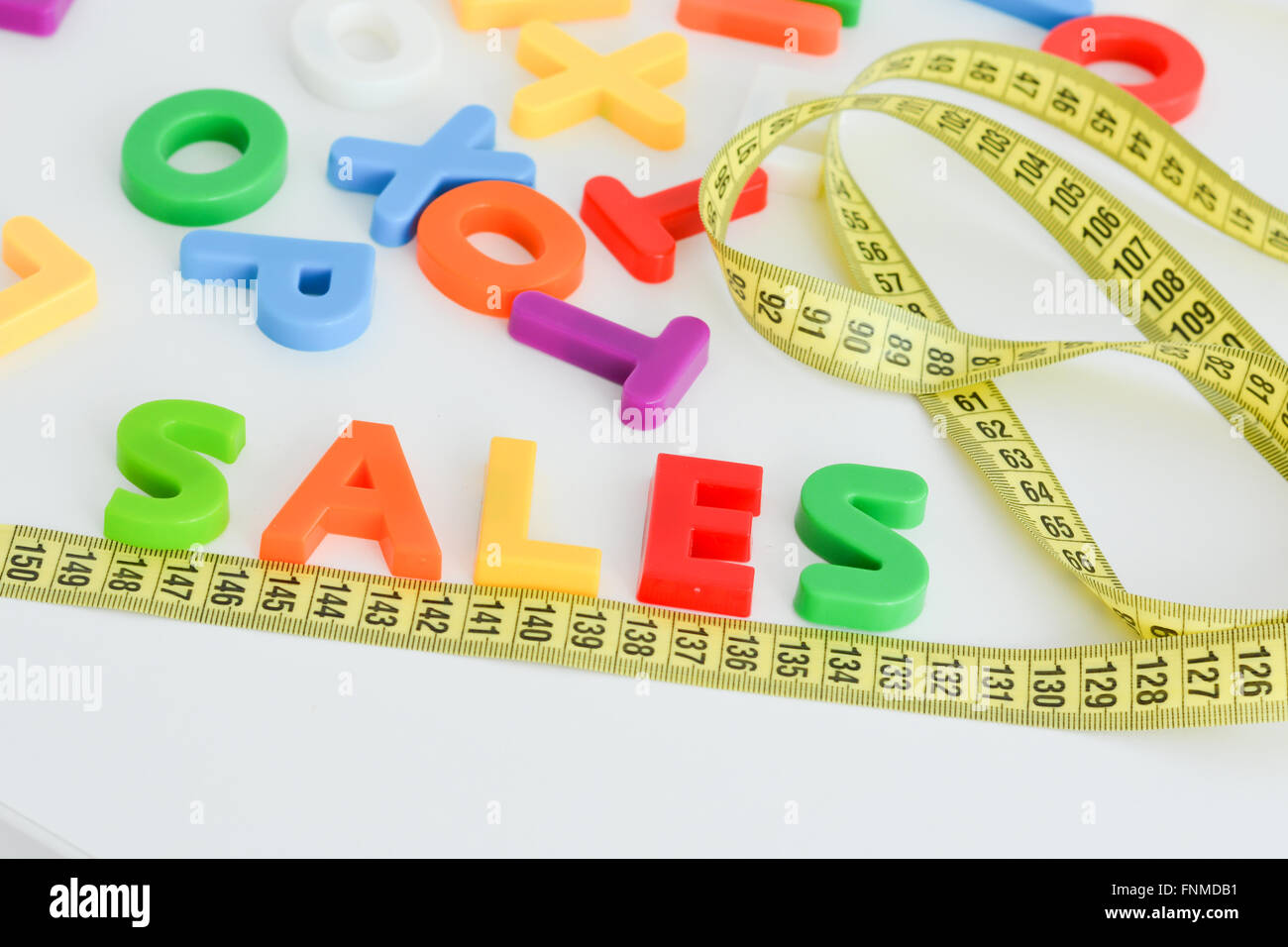 Measurement of sales concept with colored letter blocks Stock Photo