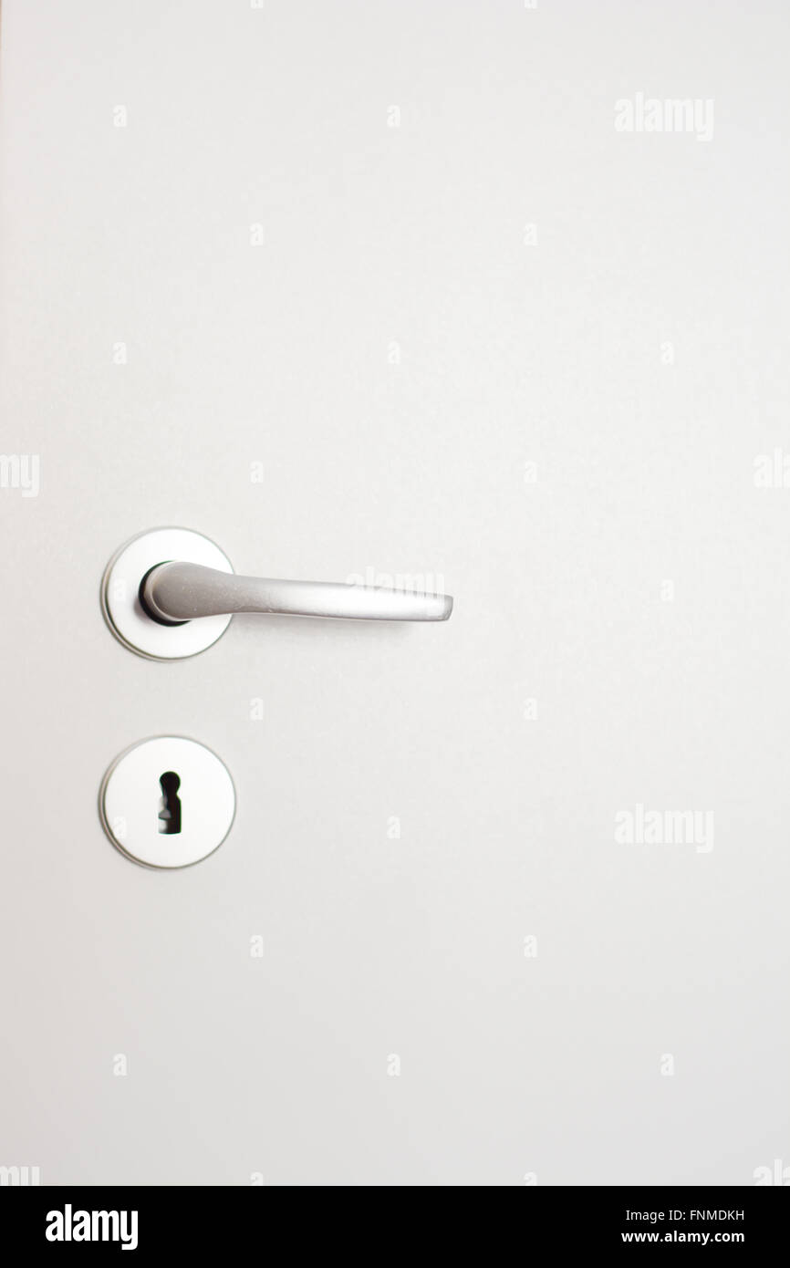 Close-up of a doorknob on white wood door Stock Photo