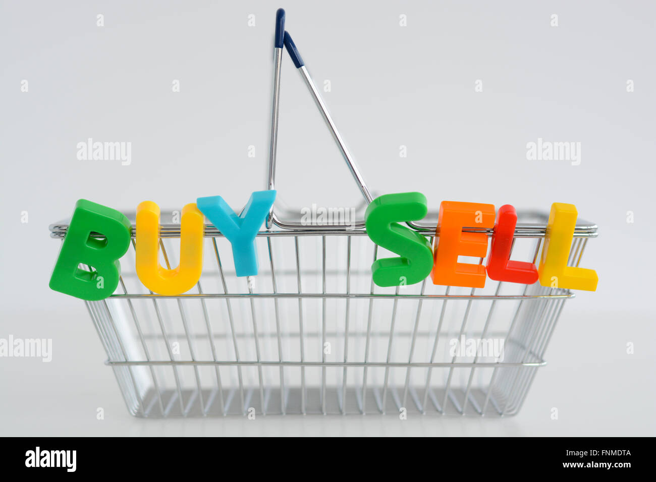 Buy and sell magnetic letters on a shopping basket Stock Photo