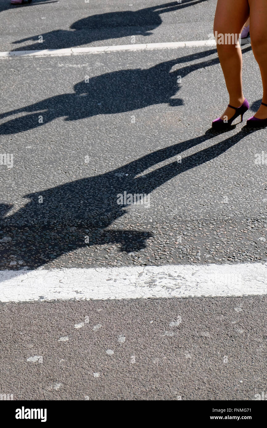 Shadow of of woman on a pavement Stock Photo