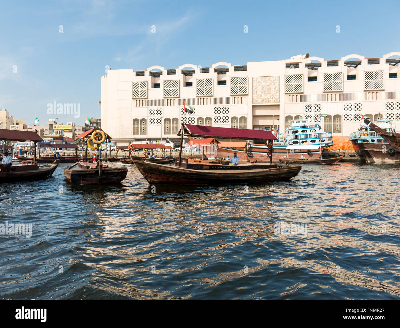 Wooden boats called abra water taxis for public transport across the Creek from Deira to Bur Dubai in Dubai, Emirates Stock Photo