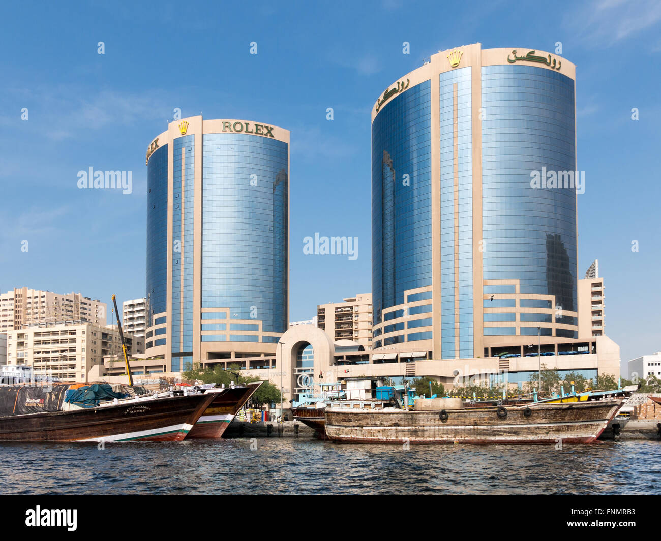 Dhow boats and Deira Twin Towers or Rolex Towers in Rigga Al Buteen in Deira, the Creek, Dubai, United Arab Emirates Stock Photo