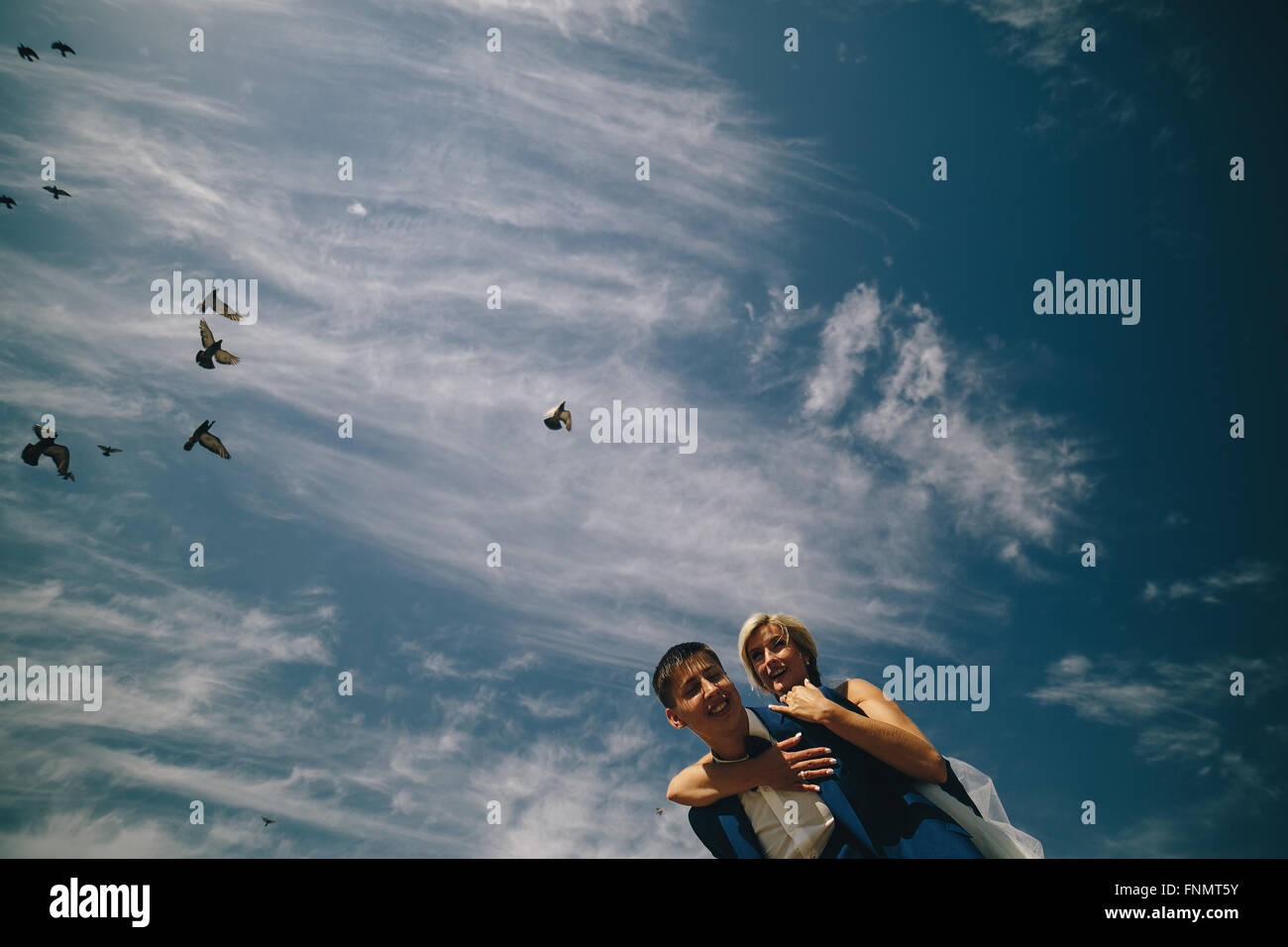 bride and groom on the background of sky Stock Photo - Alamy