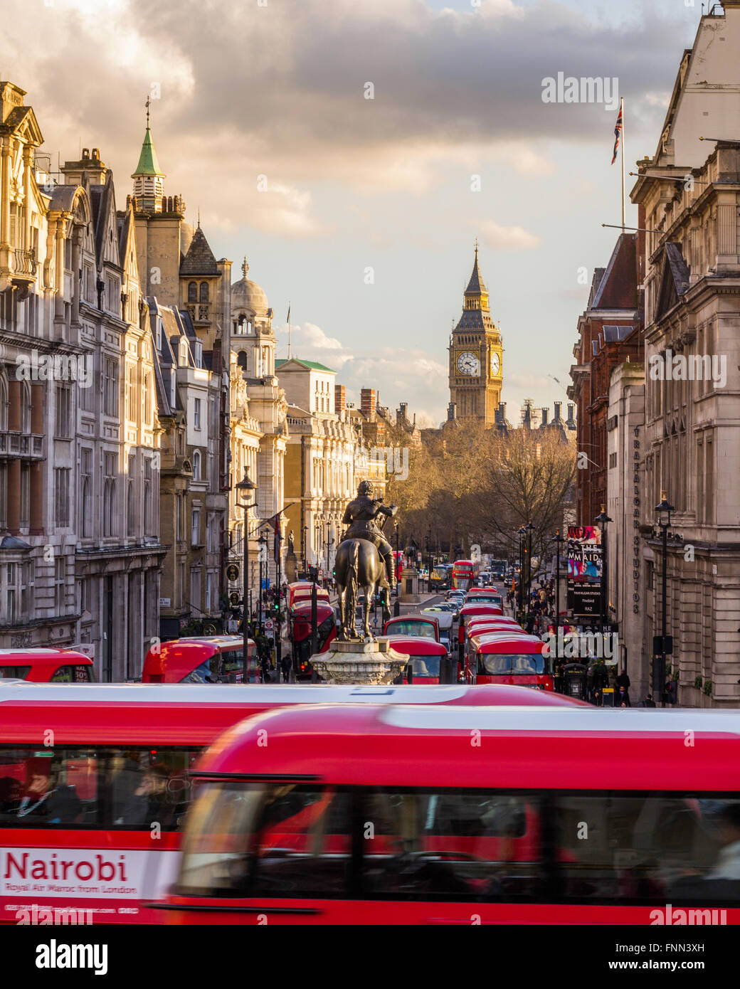 A sunset captured form Trafalgar Square looking toward Elizabeth Tower, over a road crowded of bus, London, England. Stock Photo