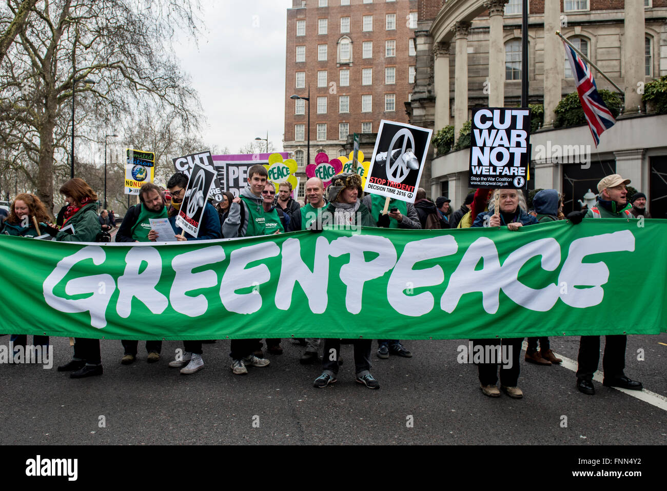 members of greenpeace environmental organization carry stock 