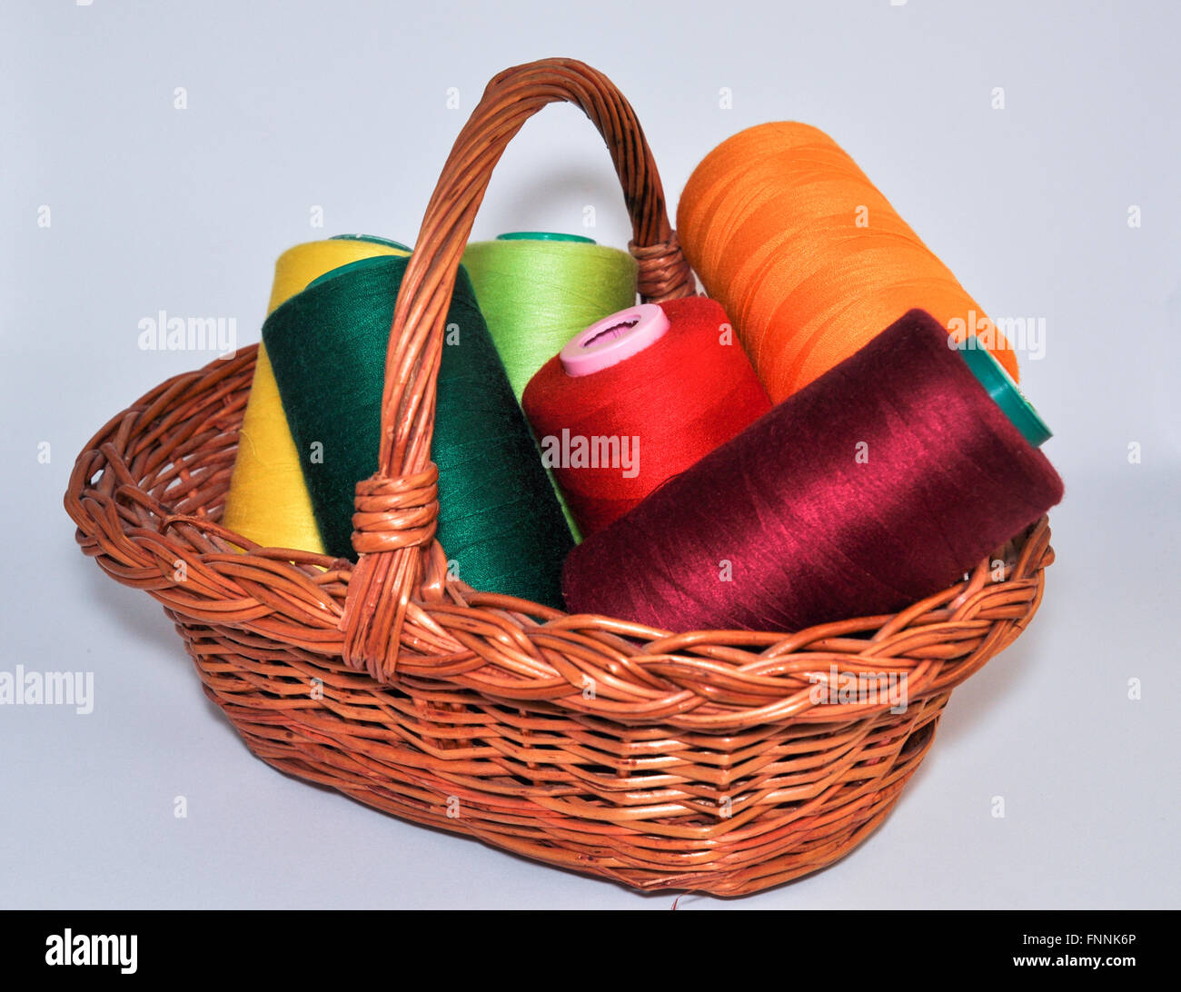 Set for sewing and embroidery in a wicker basket on a white background Stock Photo Alamy