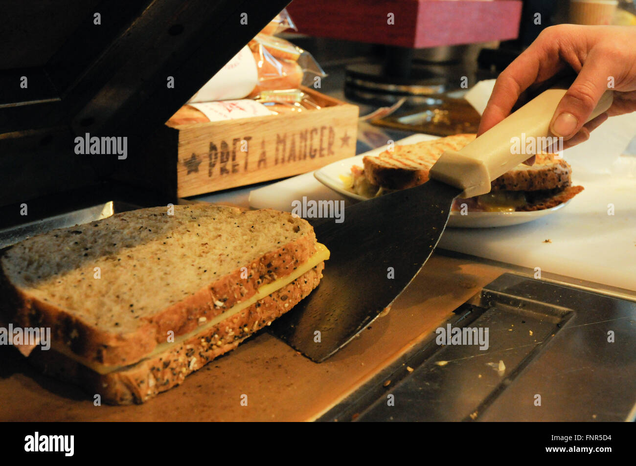 Pret a Manger cheese and ham toasted sandwich being prepared Stock