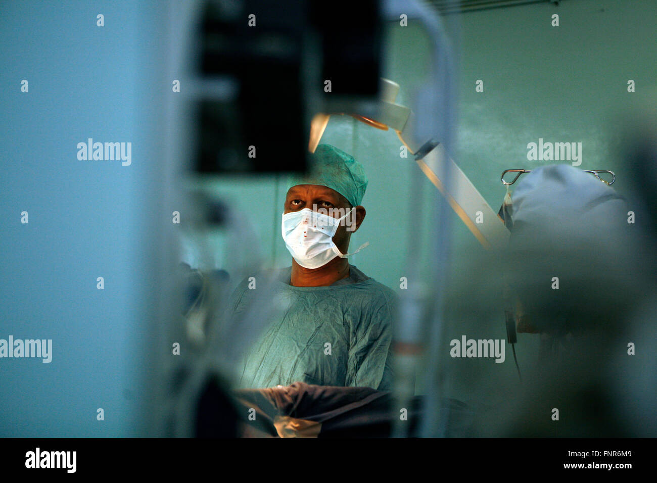 A surgeon watches a monitor, which is showing the images obtained by the laparoscope. Using the monitor the surgeon is able to g Stock Photo