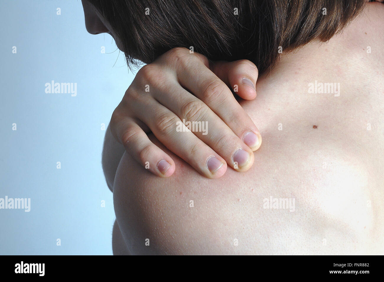 A teenage boy flexes his muscles Stock Photo