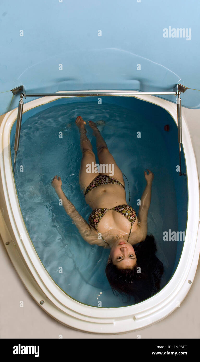Floatation Therapy being undertaken by a woman using a float tank. Stock Photo