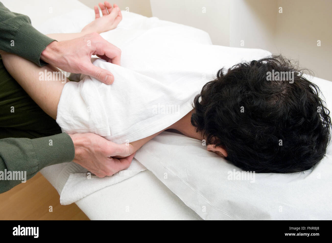Wrapping patients in lots of blankets to help them sweat is an important part of acupuncture treatment for body aches and colds. Stock Photo