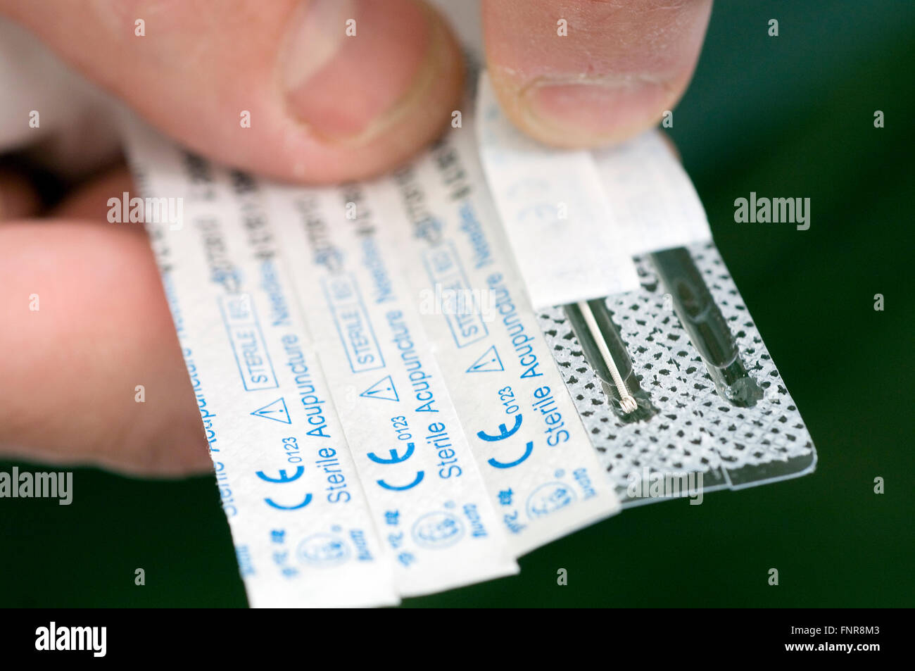 Individual packs of sterilized acupuncture needles. About the width of