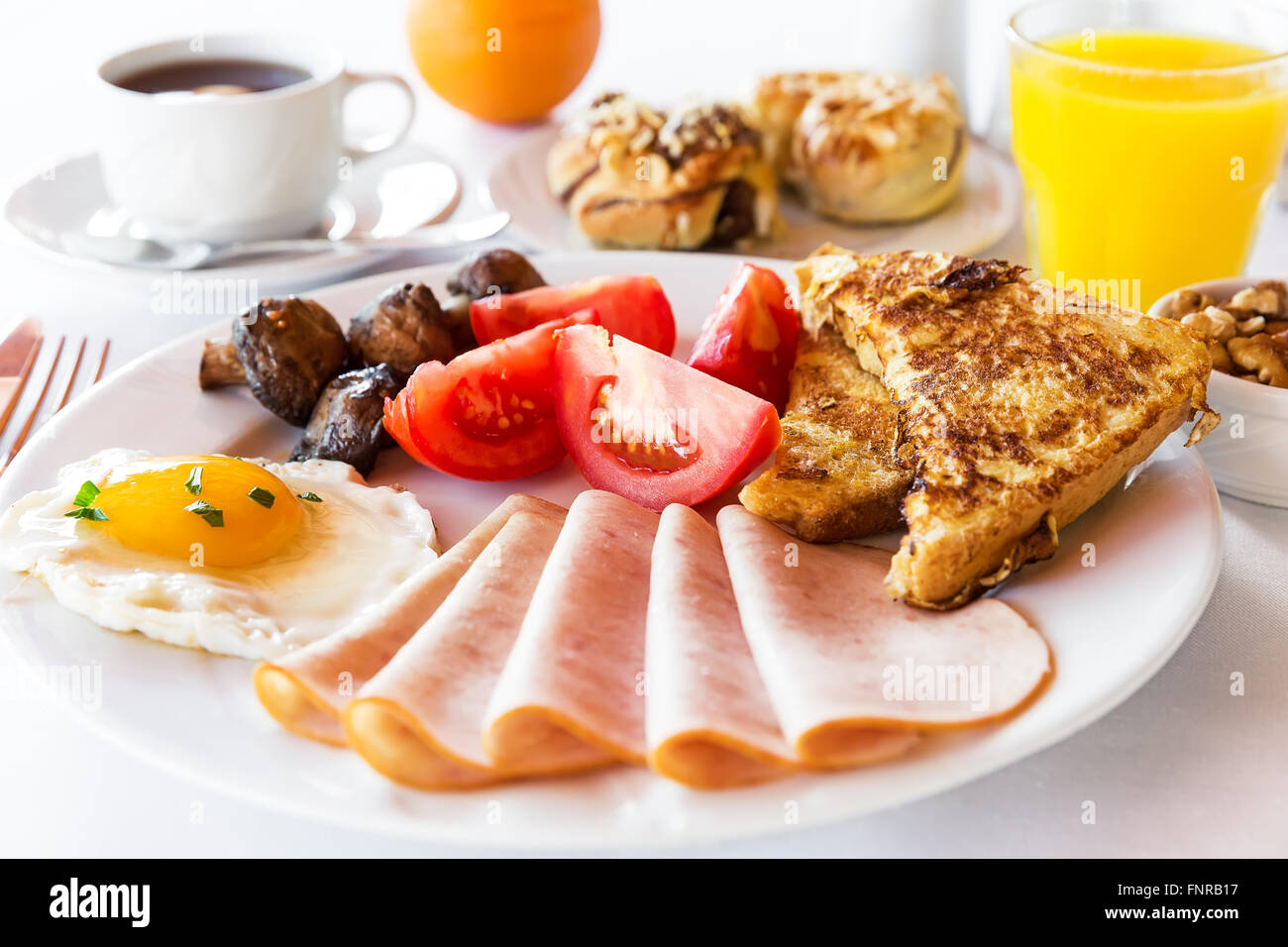 Traditional english breakfast with egg, bacon, mushrooms and tea Stock