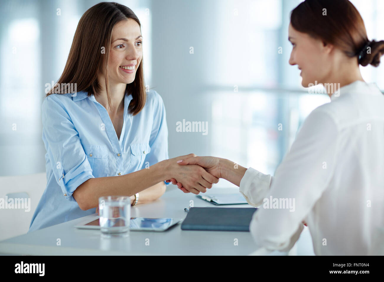 Personal manager greeting a woman at job interview Stock Photo