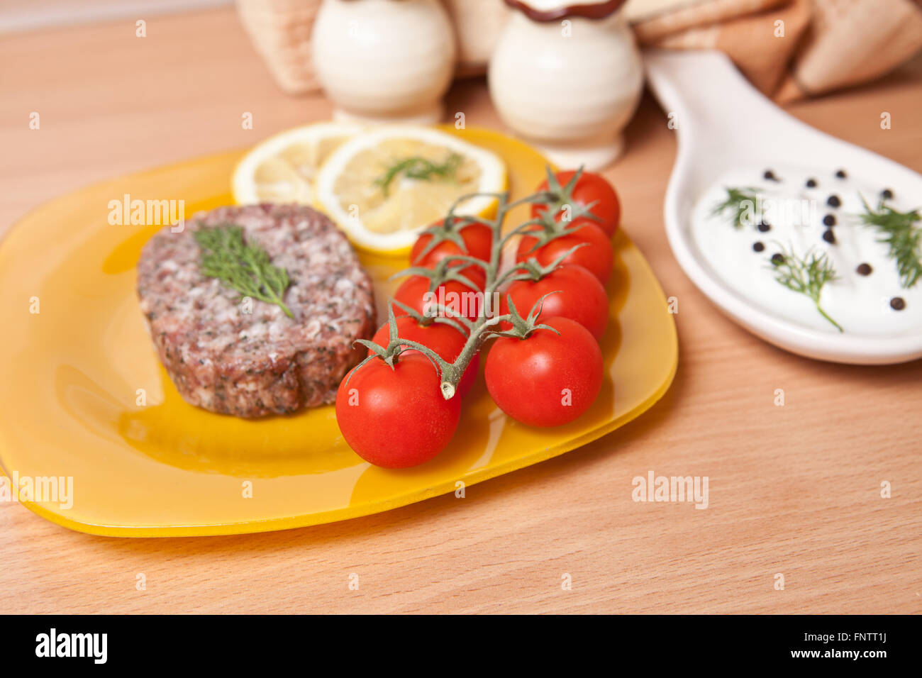 cutlet on a plate with cherry tomatoes Stock Photo
