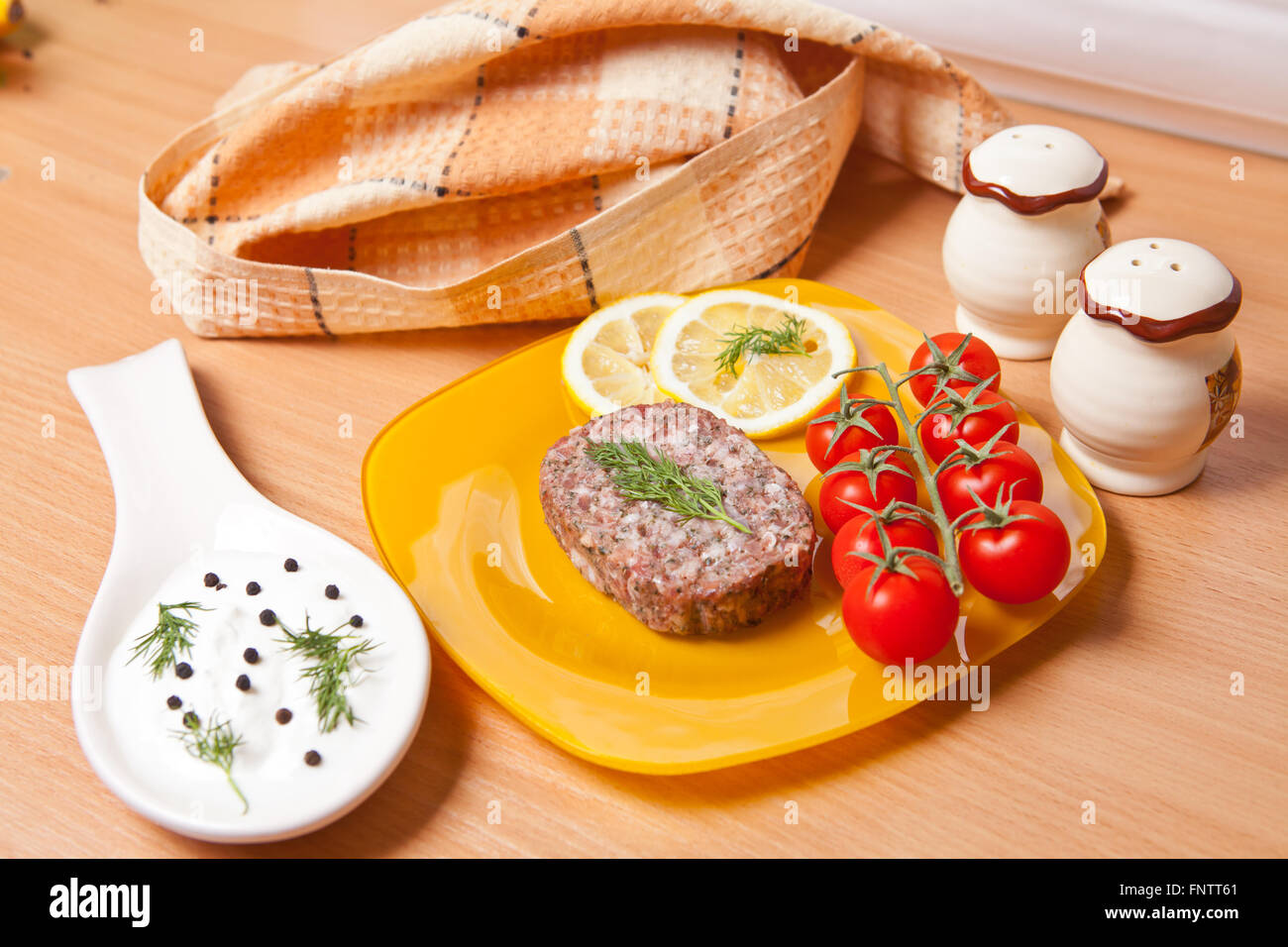 cutlet on a plate with cherry tomatoes Stock Photo