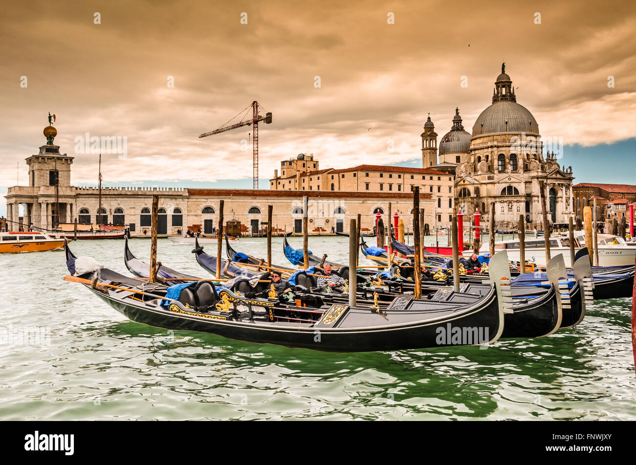 Venice Italy. Beautiful view of traditional Gondola on famous Canal Grande with Basilica di Santa Maria della Salute. Stock Photo