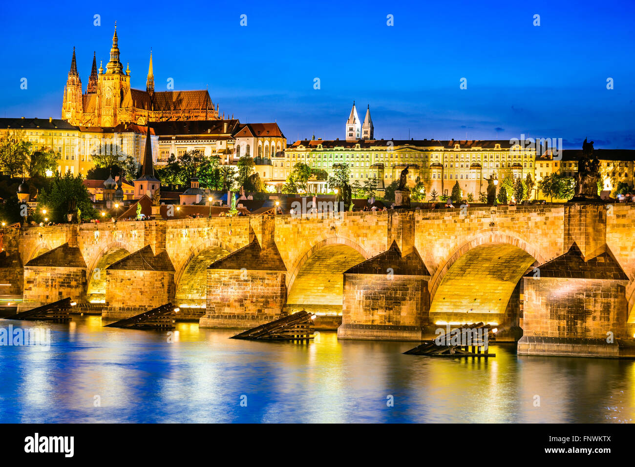 Prague, Czech Republic. Charles Bridge and Hradcany (Prague Castle) with St. Vitus Cathedral and St. George church evening dusk, Stock Photo