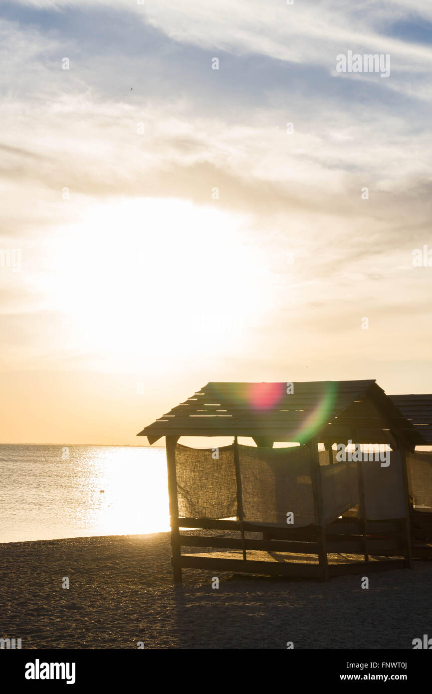 Beach huts for shelter from the sun at sunset Stock Photo - Alamy