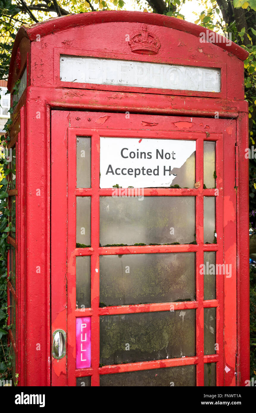 Old surviving Post Office telephone box now converted to coinless operation in a rural village Stock Photo