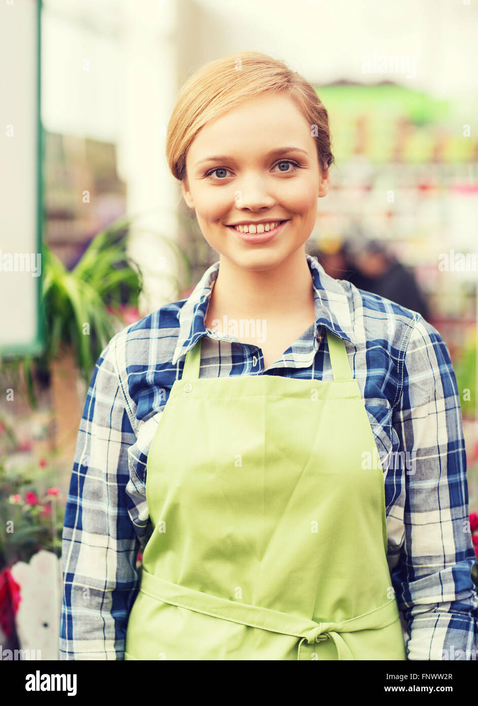 happy woman with flowers in greenhouse Stock Photo - Alamy