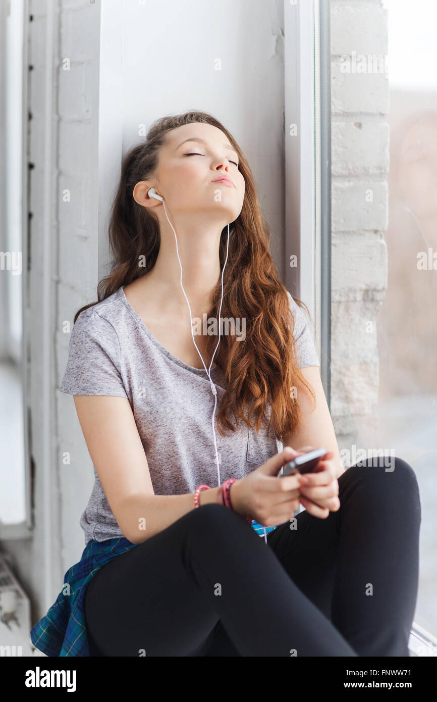 teenage girl with smartphone and earphones Stock Photo - Alamy
