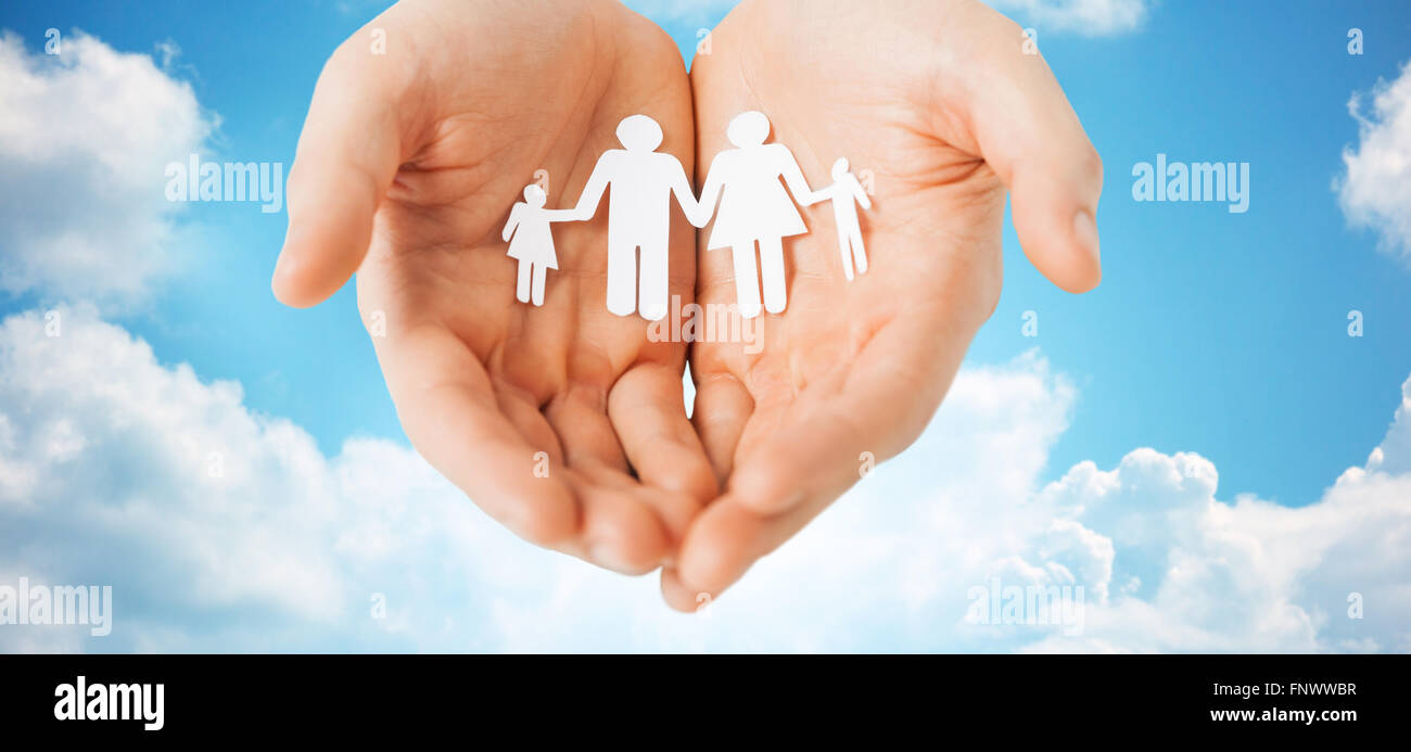 man hands holding paper cutout of family Stock Photo - Alamy