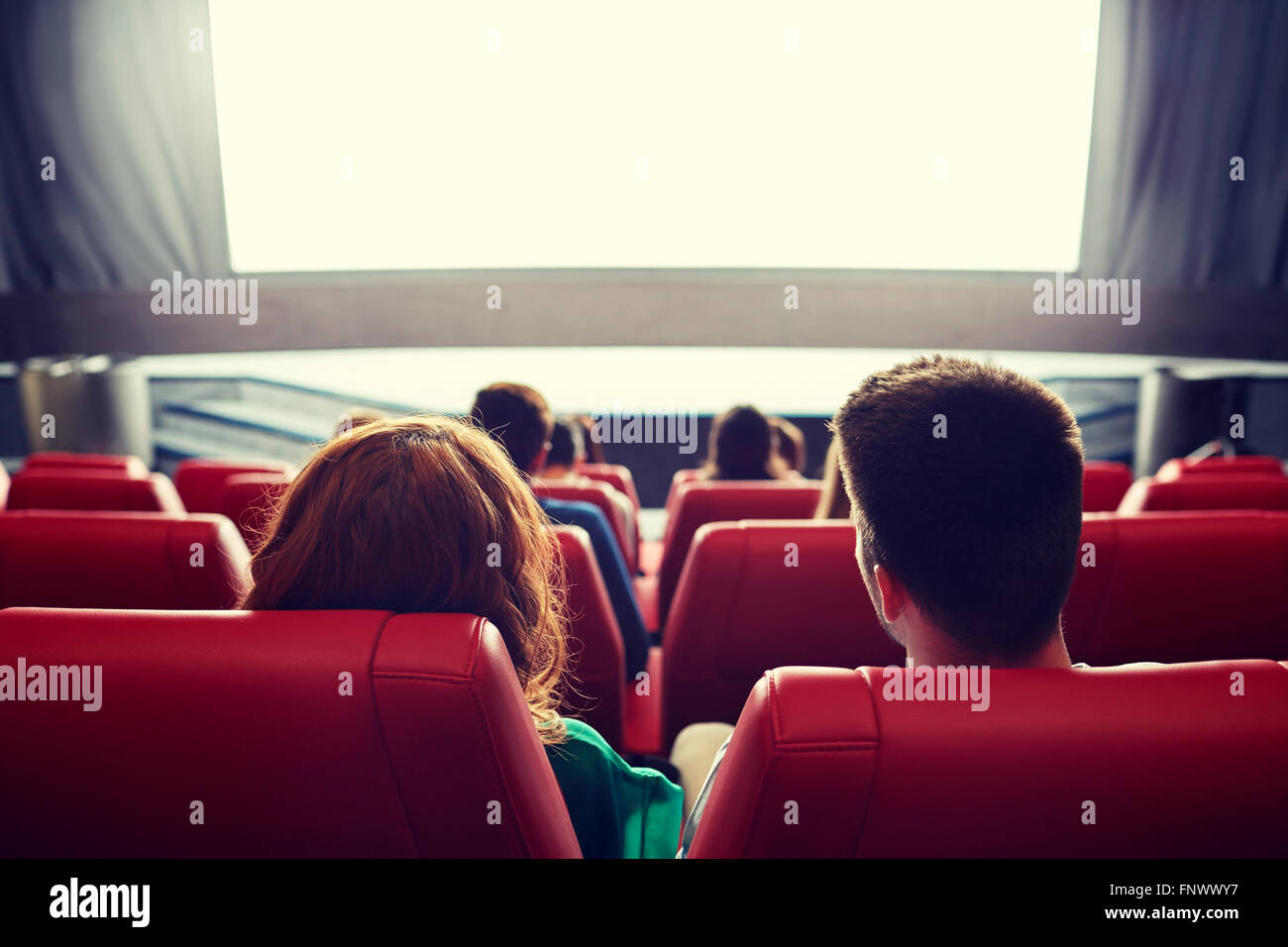 happy couple watching movie in theater or cinema Stock Photo
