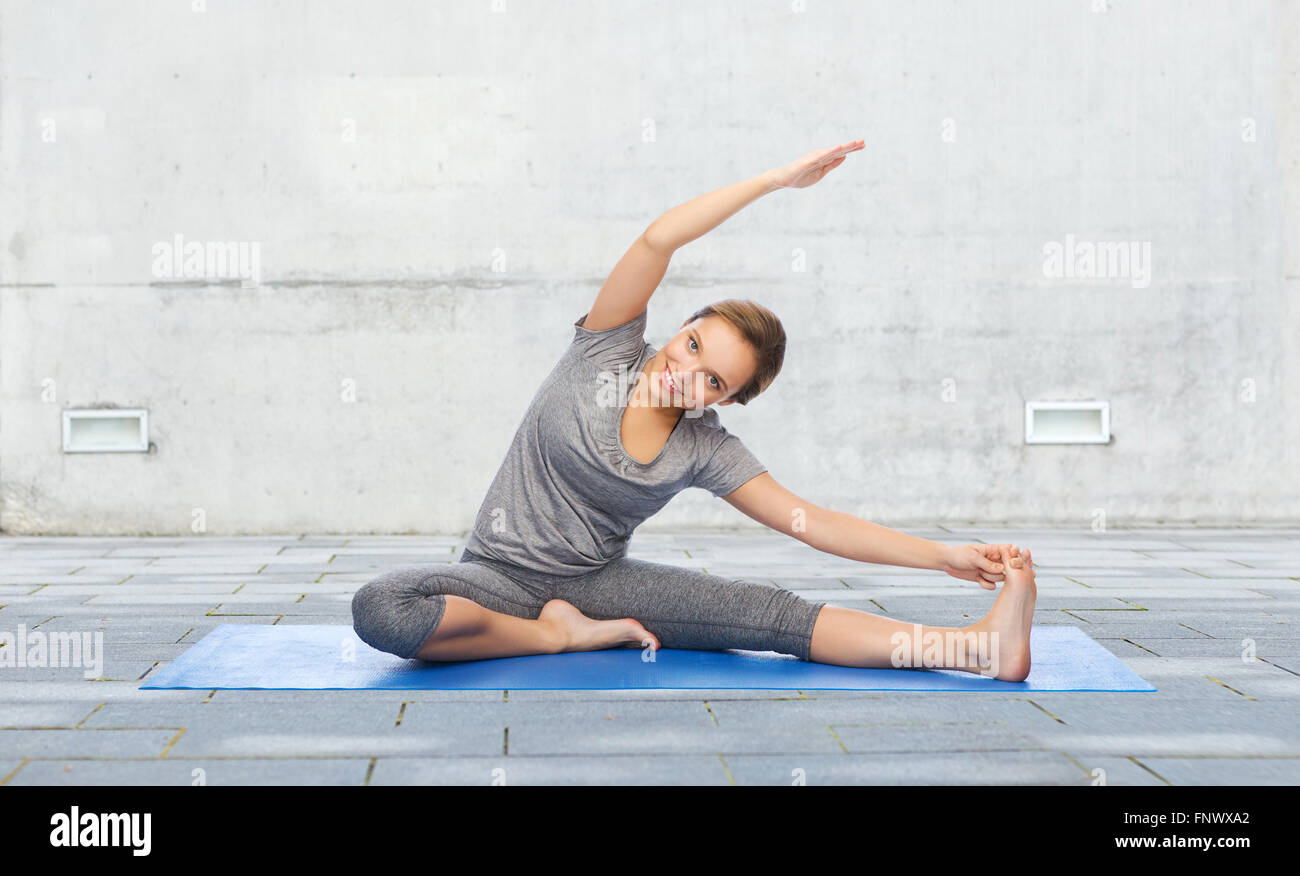 happy woman making yoga and stretching on mat Stock Photo - Alamy