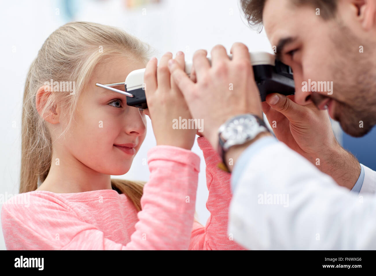 optician with pupilometer and patient Stock Photo