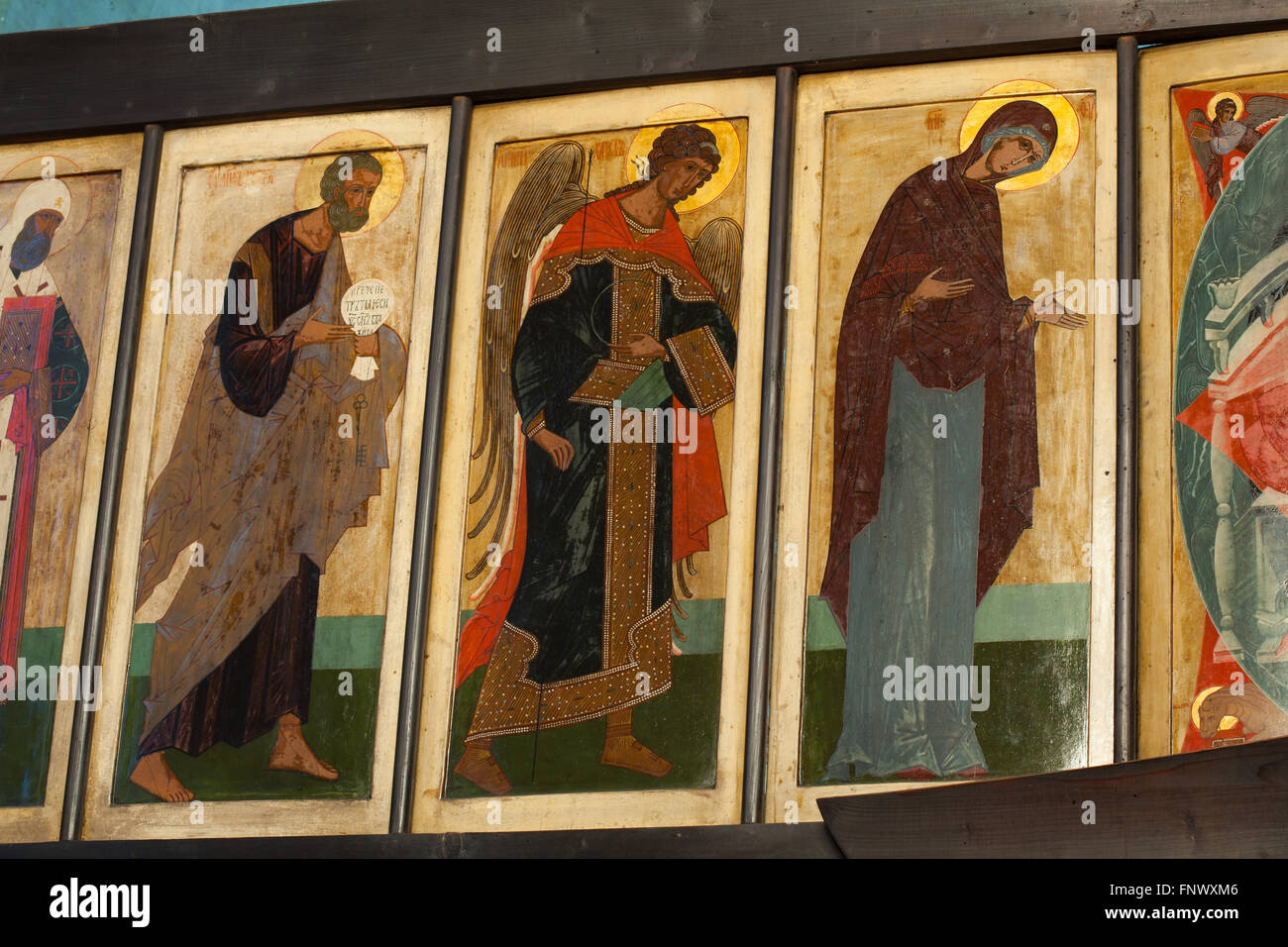 Saint Peter, Archangel Michael and Virgin Mary. Icons by Russian icon painter Kirill Katkov (1905-1995) in the deesis row of the iconostasis of the Dormition Church at the Olsany Cemetery in Prague, Czech Republic. The Dormition Church designed by Russian architect Vladimir Brandt (1887-1944) was built in 1924-1925 by the Russian white emigration in Czechoslovakia. Mural paintings were realised in 1941-1945 by group of Russian icon painters after design by famous Russian book illustrator Ivan Bilibin (1876-1942) from 1926-1928. Stock Photo