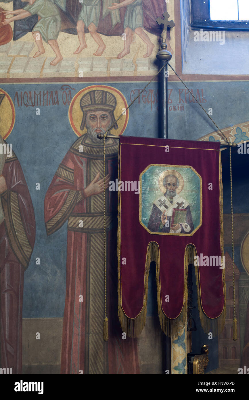 Saint Stefan of Serbia. Mural paintings by Russian icon painter Andrei Ryazanov (1885-1950) in the Dormition Church at the Olsany Cemetery in Prague, Czech Republic. Saint Nicholas the Wonderworker depicted in the khorugv (religious banner) is also a work by Andrei Ryazanov. The Dormition Church designed by Russian architect Vladimir Brandt (1887-1944) was built in 1924-1925 by the Russian white emigration in Czechoslovakia. Mural paintings were realised in 1941-1945 by group of Russian icon painters after design by famous Russian book illustrator Ivan Bilibin (1876-1942) from 1926-1928. Stock Photo