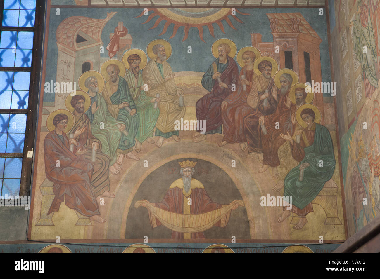 Descent of the Holy Spirit on the Apostles. Mural painting by Russian icon painters Rostislav Koryakin (1918-1999) and Andrei Ryazanov (1885-1950) in the Dormition Church at the Olsany Cemetery in Prague, Czech Republic. An allegorical figure at the bottom called Kosmos symbolizes the world. The Dormition Church designed by Russian architect Vladimir Brandt (1887-1944) was built in 1924-1925 by the Russian white emigration in Czechoslovakia. Mural paintings were realised in 1941-1945 by group of Russian icon painters after design by famous Russian book illustrator Ivan Bilibin (1876-1942) from Stock Photo