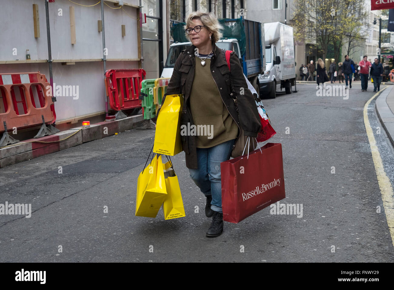 A woman leaves a shopping mall laden with bags, Thursday, Dec. 15, 2005,  after shopping at T.J. Maxx in the Chelsea neighborhood of New York. A  record plunge in the cost of