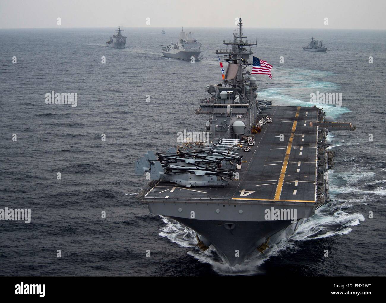 US Navy amphibious assault ship USS Boxer steams in formation along ...