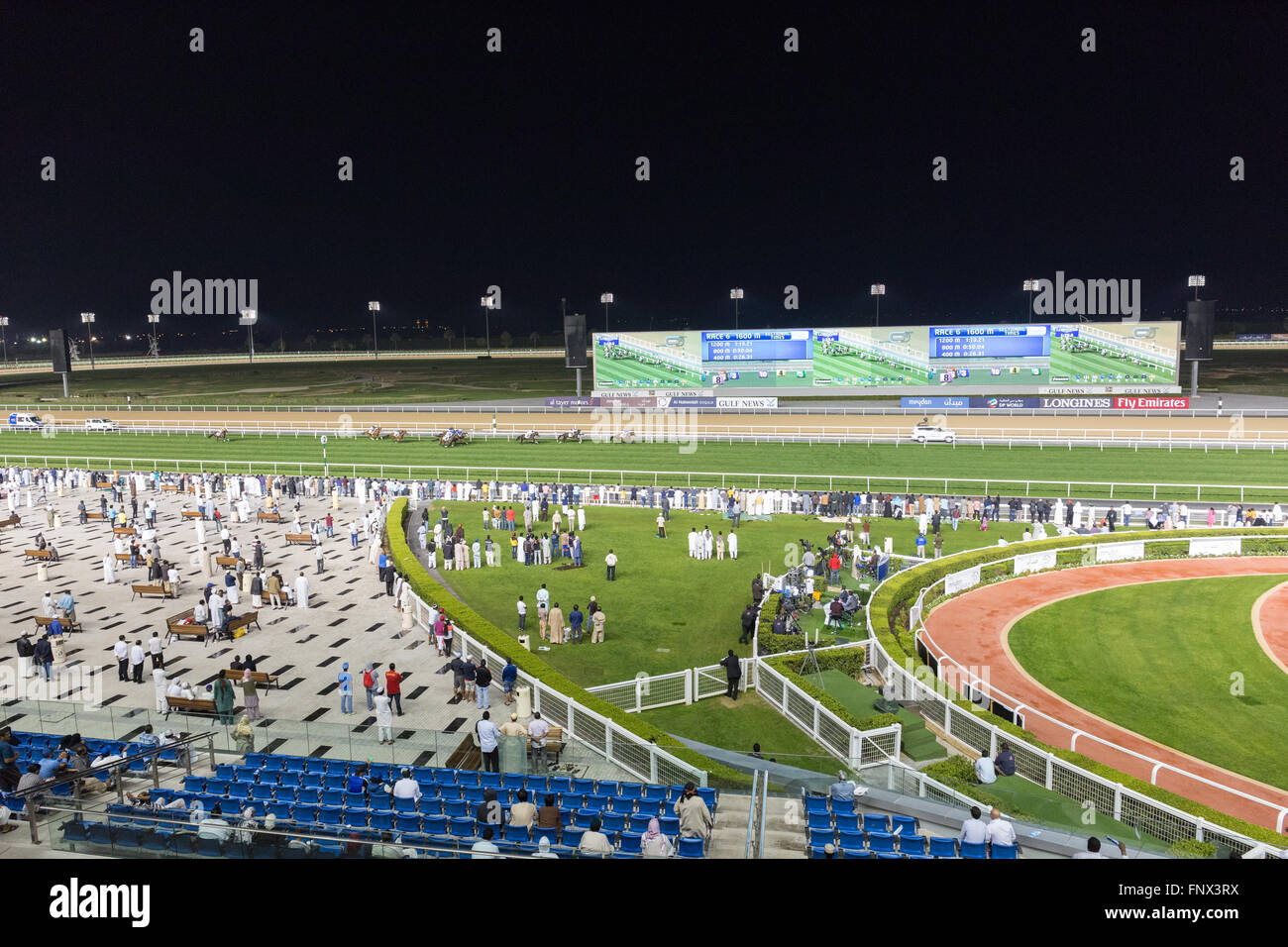 Spectators watching horse racing at The Meydan, Dubai UAE Stock Photo