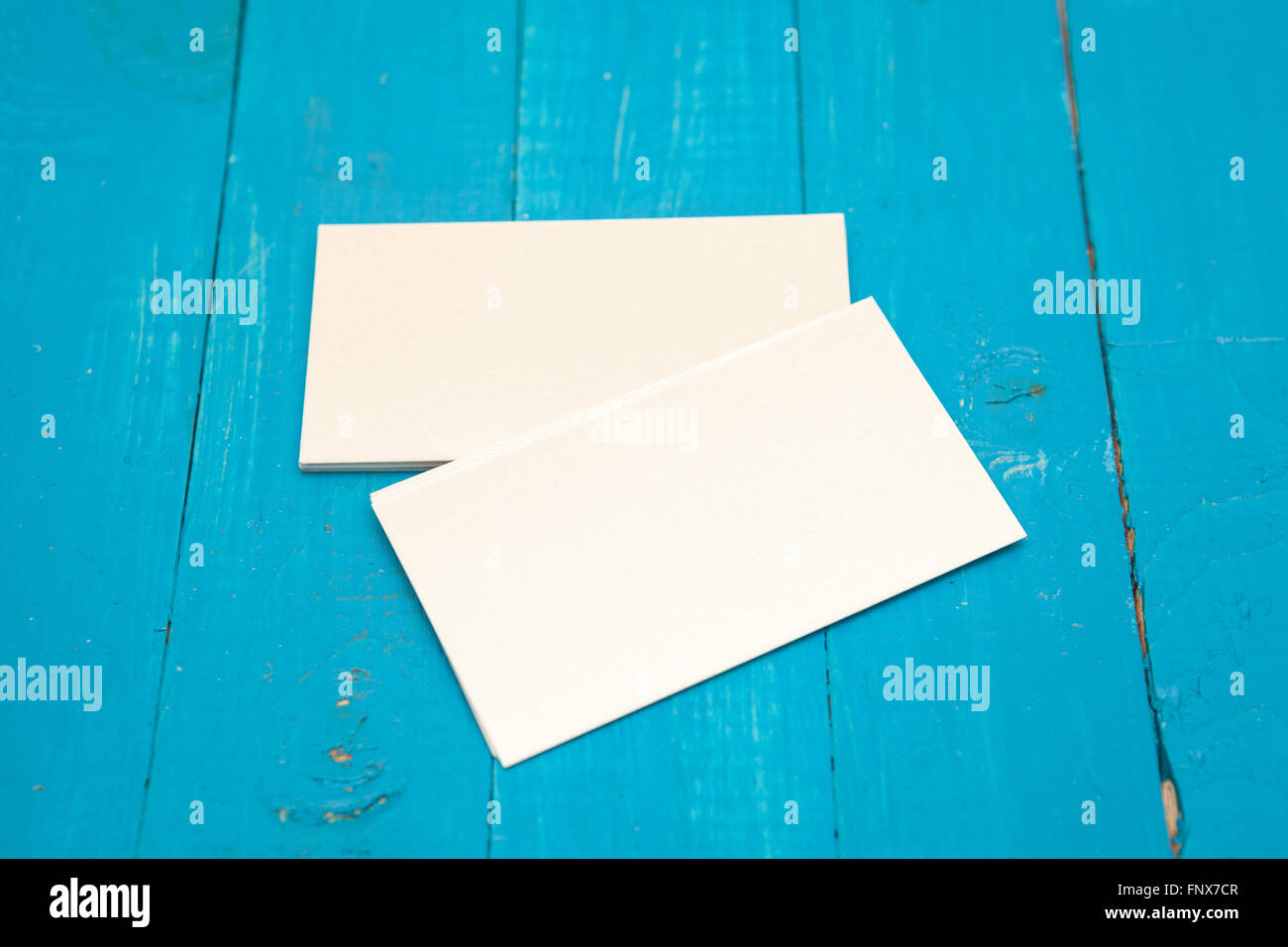 Business card on a blue wooden background. Mock-up for branding Stock Photo