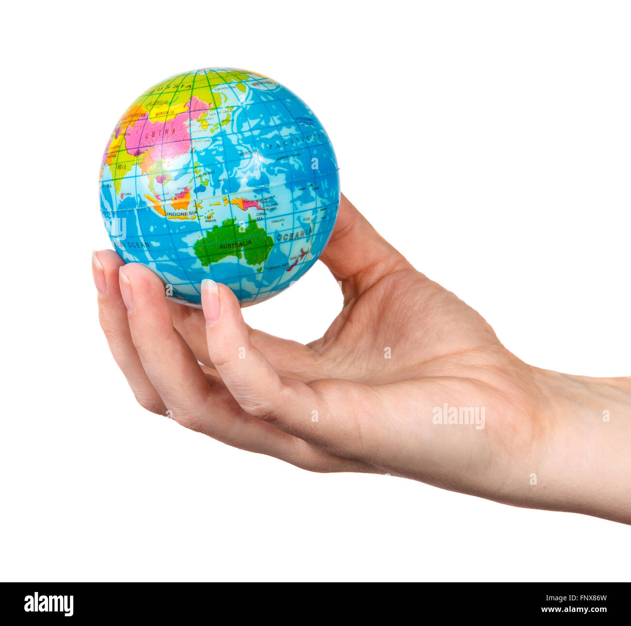 small model of the globe in the hand of the girl on a white back Stock Photo