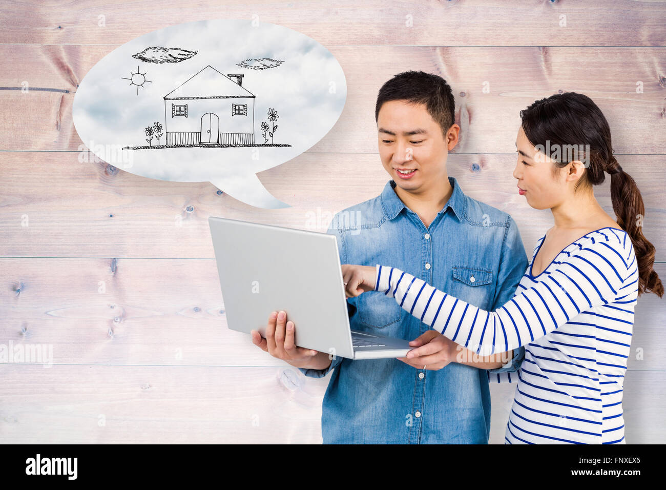 Composite image of couple using laptop Stock Photo - Alamy