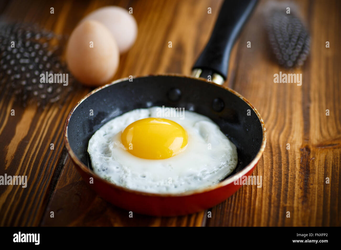fried eggs in a frying pan Stock Photo - Alamy
