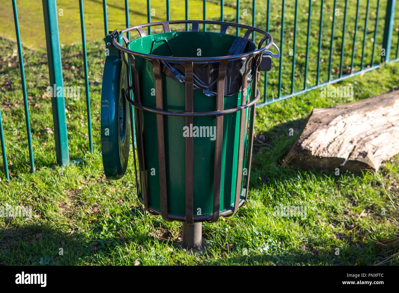 A large green waste bin in a UK park. Stock Photo