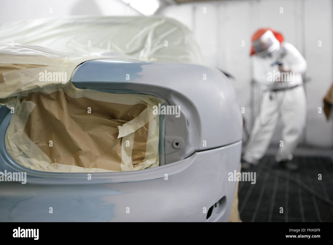 automotive repairs in the bodyshop. A car has its bodywork repaired and spray painted Stock Photo