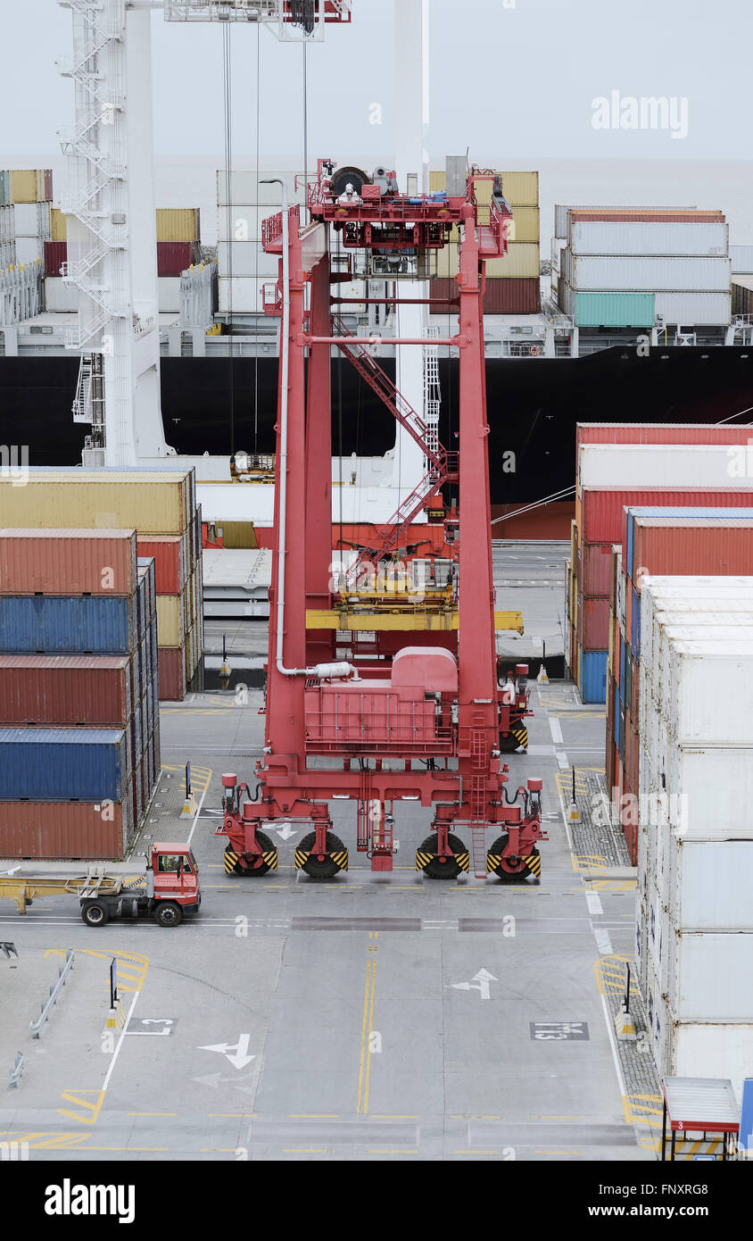Cargo containers truck and a crane in storage area of freight port