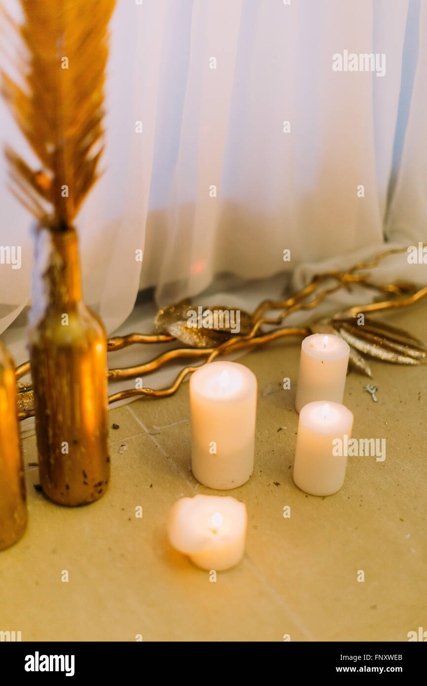 Candles on the floor close up. Details of wedding decorations Stock