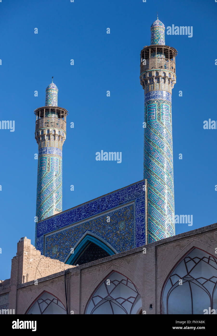 Mosaic tile clad pishtak & minarets of Imam Mosque in Imam Square, Isfahan, Iran Stock Photo