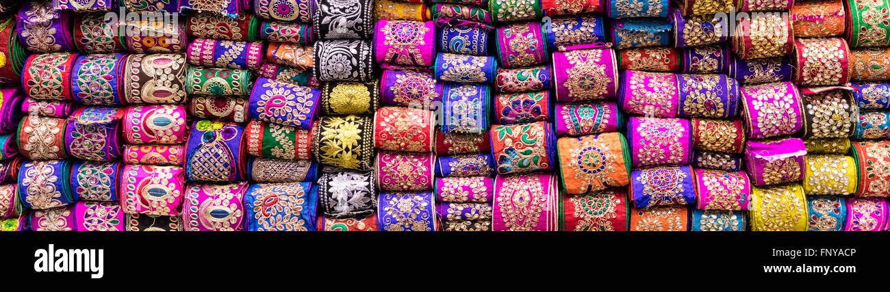 Wide angle view of colorful silver and gold thread embroidered ribbons at Hagi Bazaar, Shiraz, Iran Stock Photo