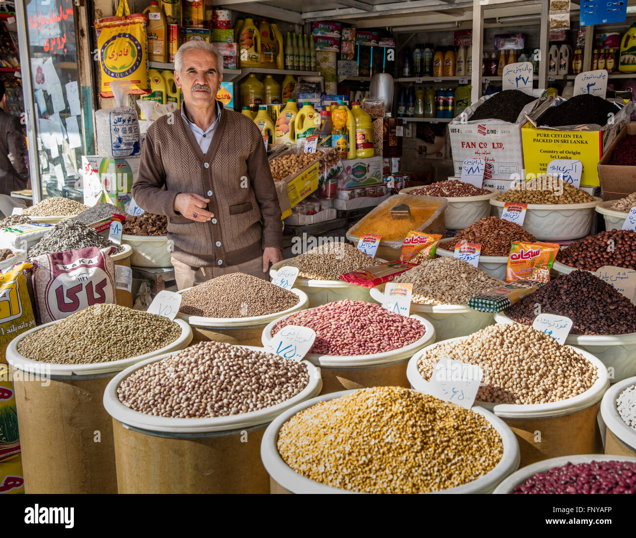 Vendor at his street stand with cereals, grains, pulses, and other food