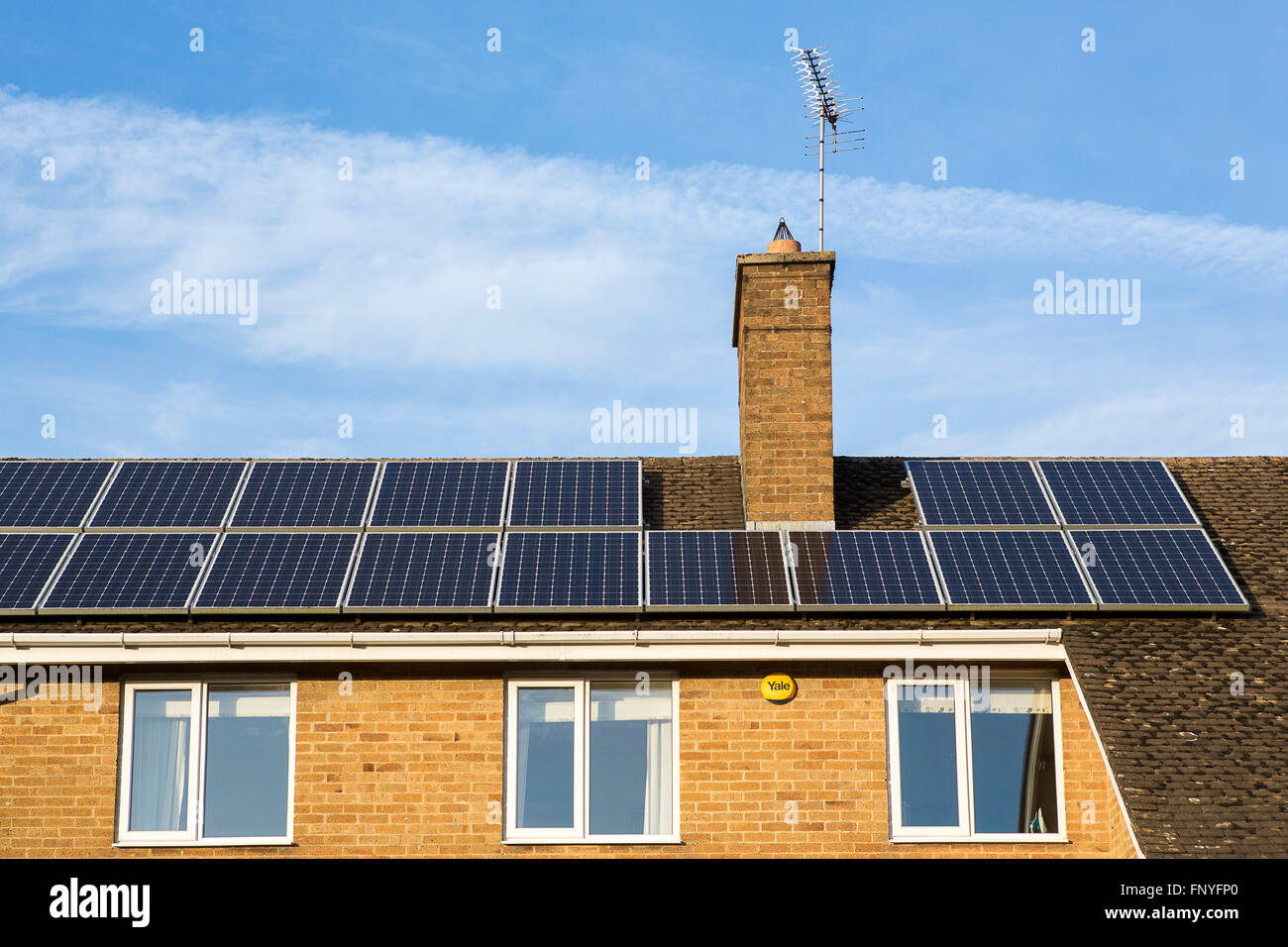 Solar panels and tiles on residential housing in the UK. Stock Photo